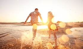 people walking hand in hand on beach