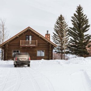 Brown wood house in the snow during winter