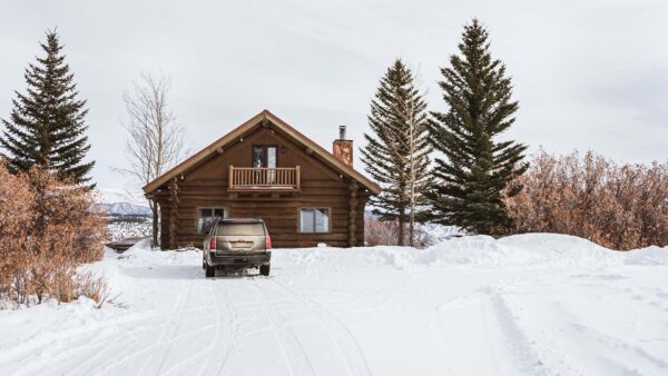 Brown wood house in the snow during winter