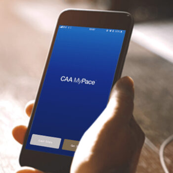 CAA logo on phone screen in hand.