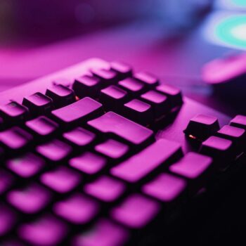 Computer keyboard under purple light