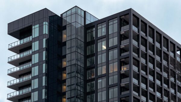 Tall condo building on a blue sky