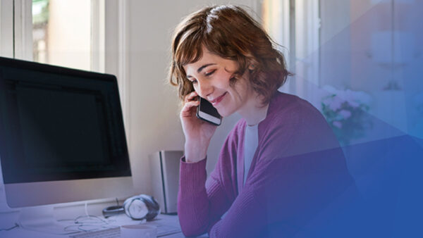 Smiling woman o phone in office setting