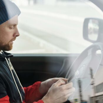 Man in Red and Black Jacket Wearing Blue Knit Cap