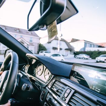 woman driving in car with hands on wheel