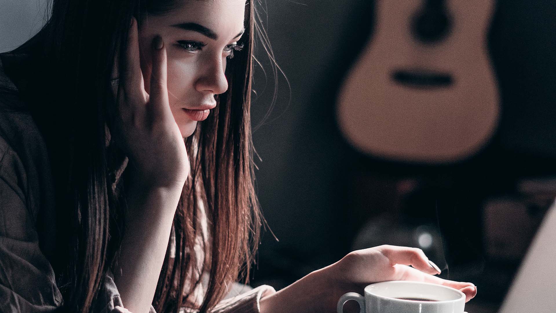 Woman having a coffee browsing on a laptop