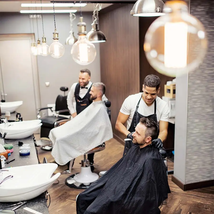 Barbers working in a shop.