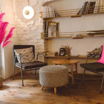 Rustic brown living room with white brick wall and two chairs