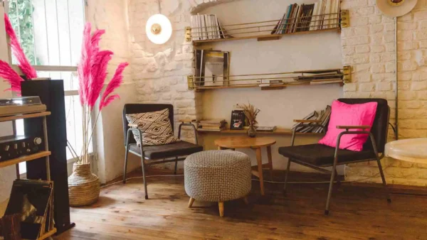 Rustic brown living room with white brick wall and two chairs