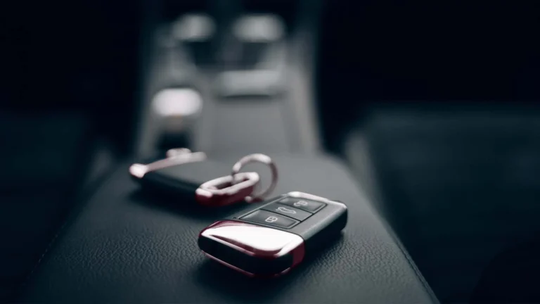 Car keys on the armrest of a rental car.