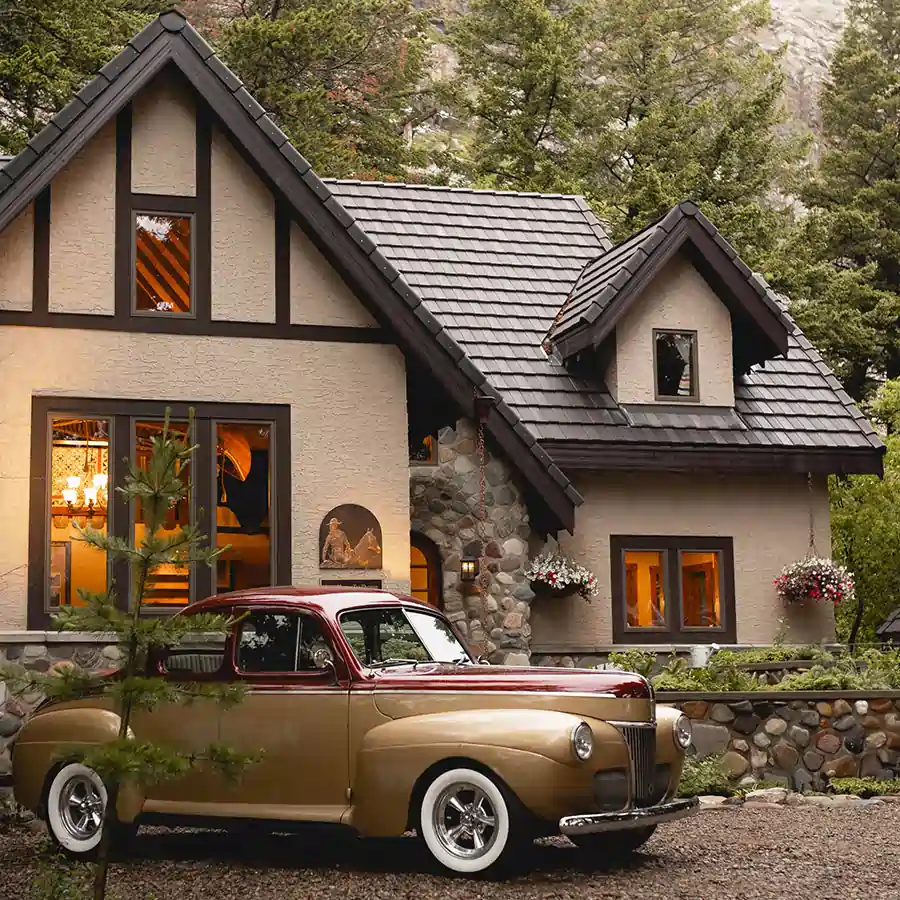 Classic car in front of a house.