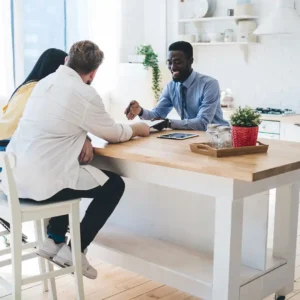 couple meeting with broker in kitchen