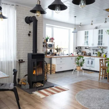 Interior of high-risk home with wood stove and hanging lights.