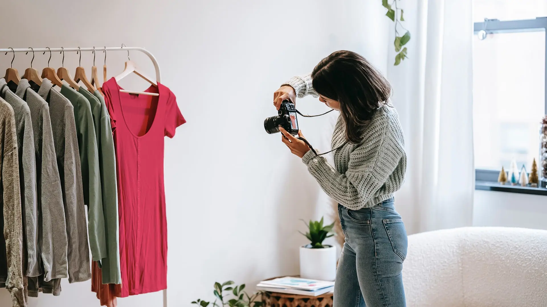 home based clothing designer taking photo of dress