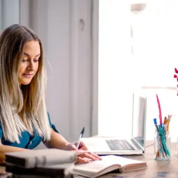 Woman working at desk of home office.