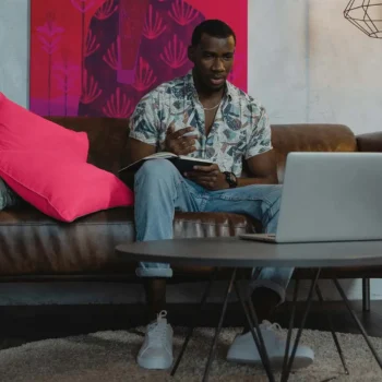 Man in Blue and White Button Up Shirt Sitting on Brown Couch