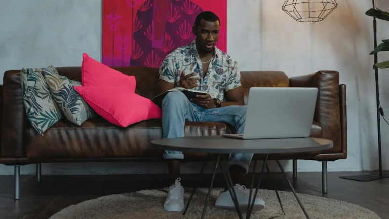 Man in Blue and White Button Up Shirt Sitting on Brown Couch