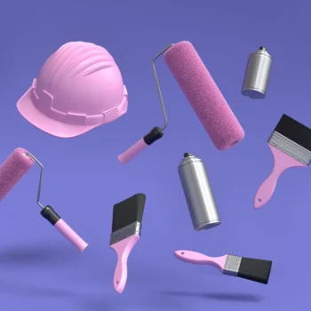 painting tools and hard hat floating on purple background