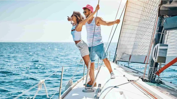 two people on a sailboat in the water