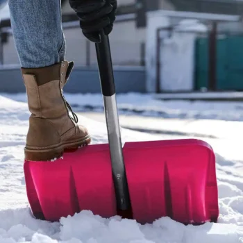 person shoveling snow on sidewalk