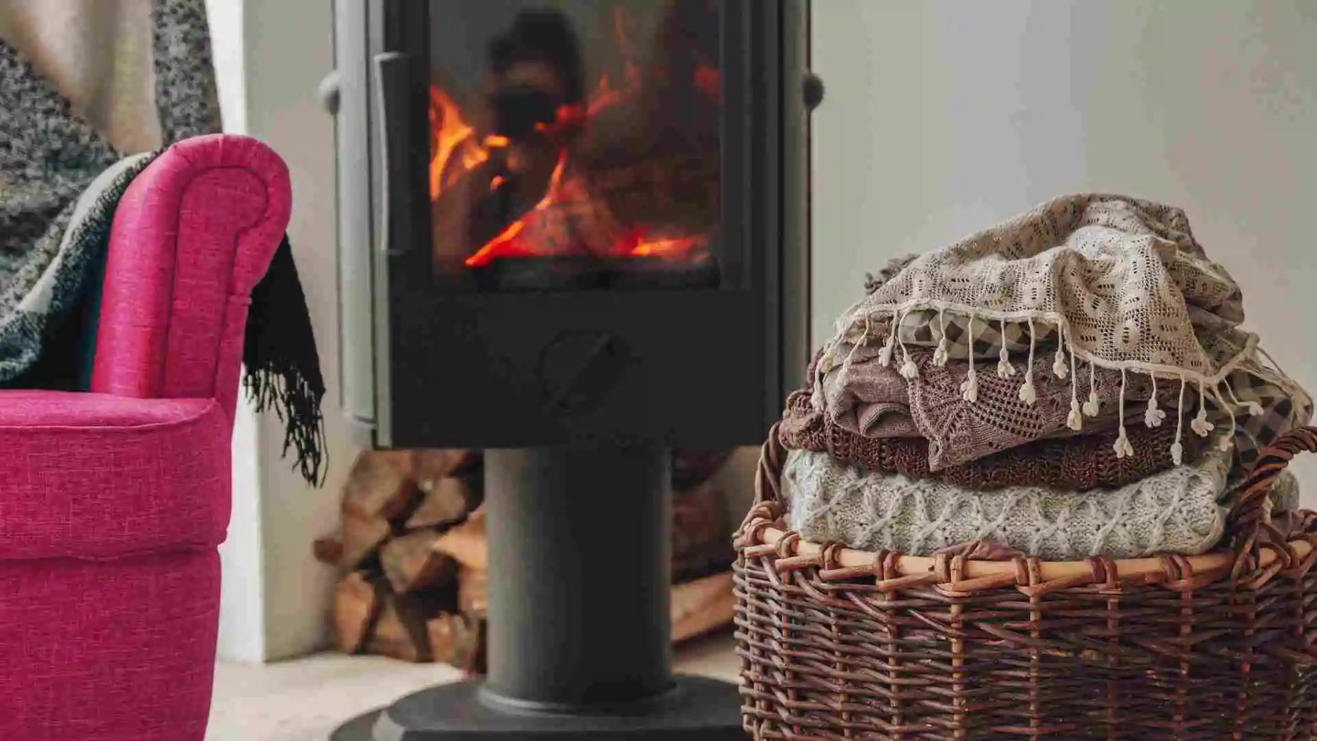 cottage wood stove and blanket basket with pink chair