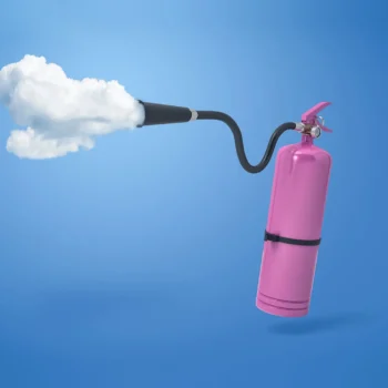 pink fire extinguisher with white cloud coming out of sprayer hose
