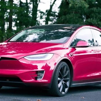 raspberry tesla parked on road