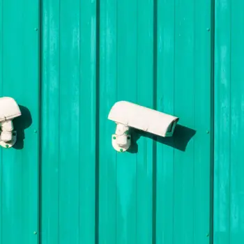 White security cameras on paneled wall.