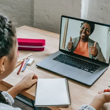 person speaking to other person on laptop