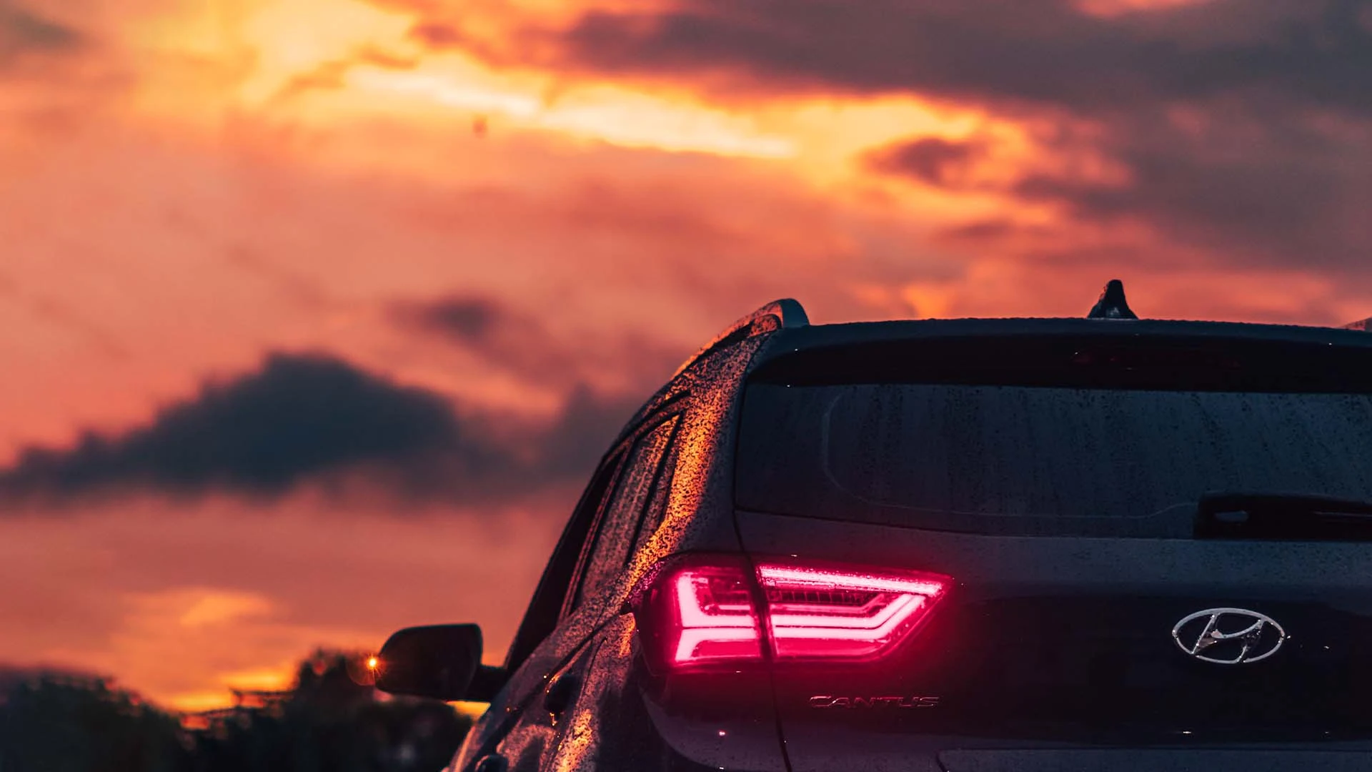 Back of a Hyundai SUV at sunset.