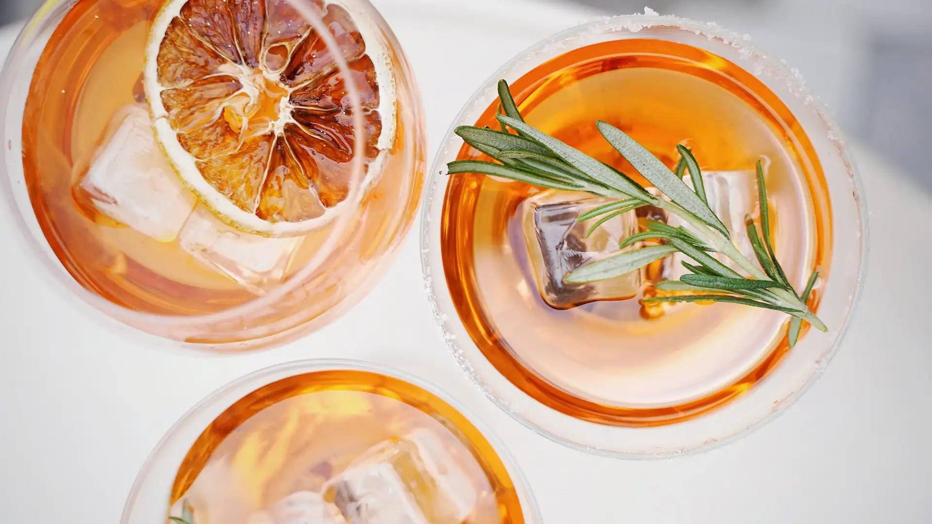 top view of three cocktails with garnishes